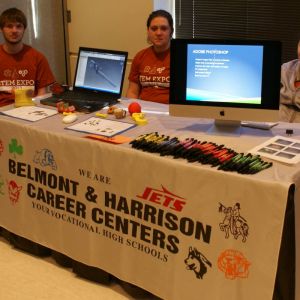 Caleb Hayes and Abagail Lutman get ready to show the Drafting/CAD program, while Jorden Traczyk displays Visual Graphics & Web Design.