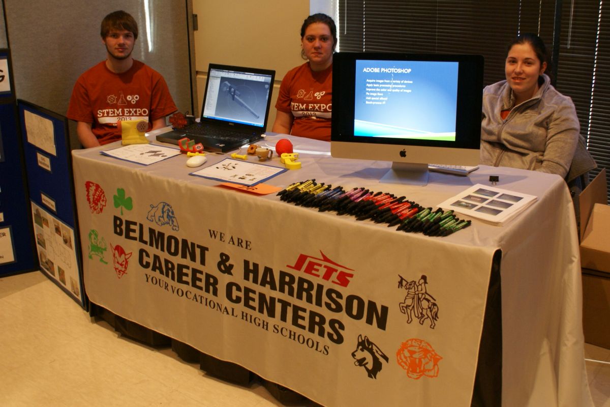 Caleb Hayes and Abagail Lutman get ready to show the Drafting/CAD program, while Jorden Traczyk displays Visual Graphics & Web Design.